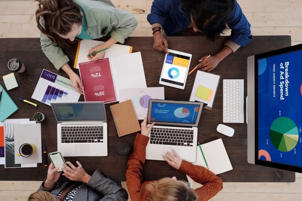 Crafting Captivating Headlines: Your awesome post title goes here A diverse team collaborating on digital marketing strategies at a desk, using laptops and tablets.